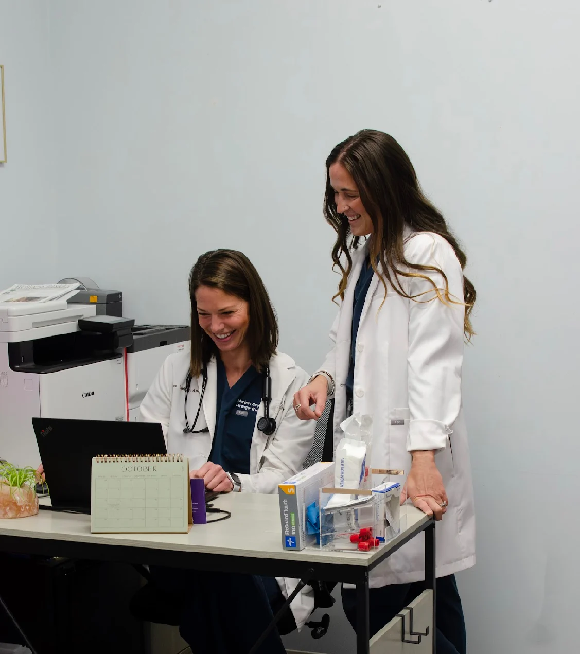 Britney Durst and Marissa Edelman working together in the practice office